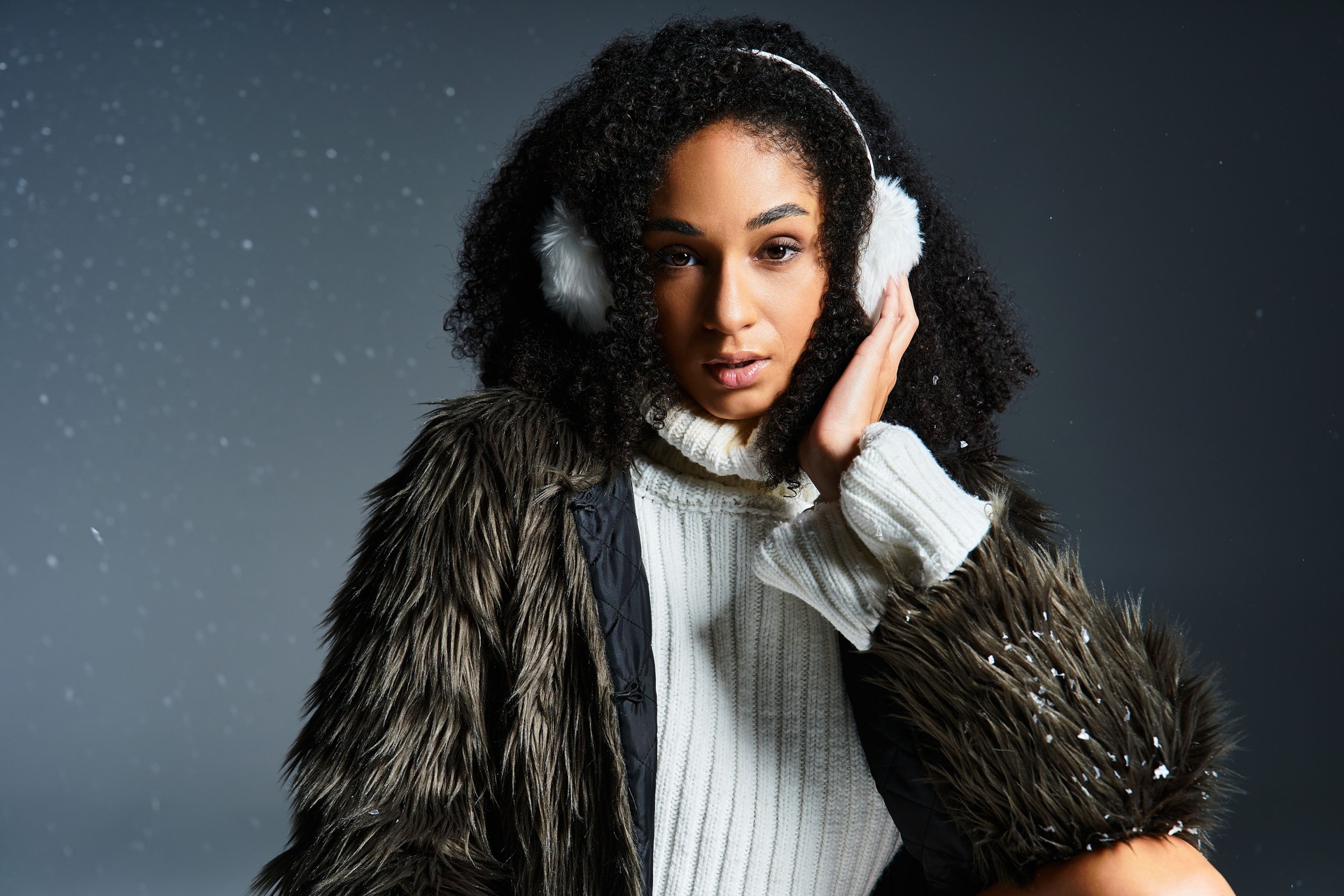 Elegant winter fashion featuring a beautiful woman in a faux fur jacket and cozy sweater